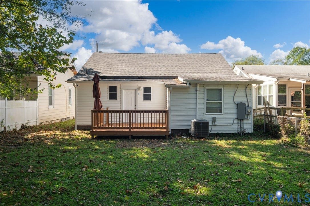 113 Spring Street, Pembroke, Petersburg, VA 23803 Rear exterior featuring white horizontal siding, a raised wood deck, a shingle roof, and a fenced backyard