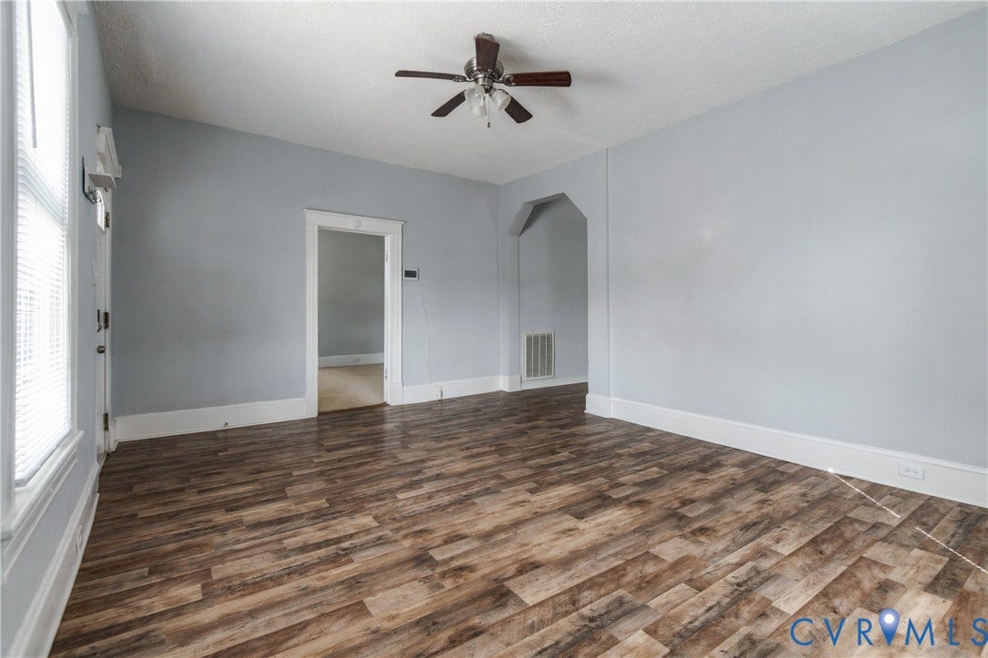 113 Spring Street, Pembroke, Petersburg, VA 23803 Room featuring wood-finish flooring, an arched entryway, and a ceiling fan with integrated lighting