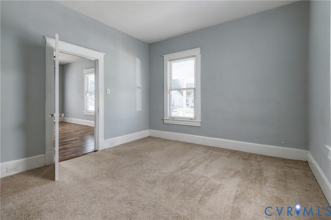 113 Spring Street, Pembroke, Petersburg, VA 23803 Room with neutral-toned carpeting, light grey walls, and white window casing