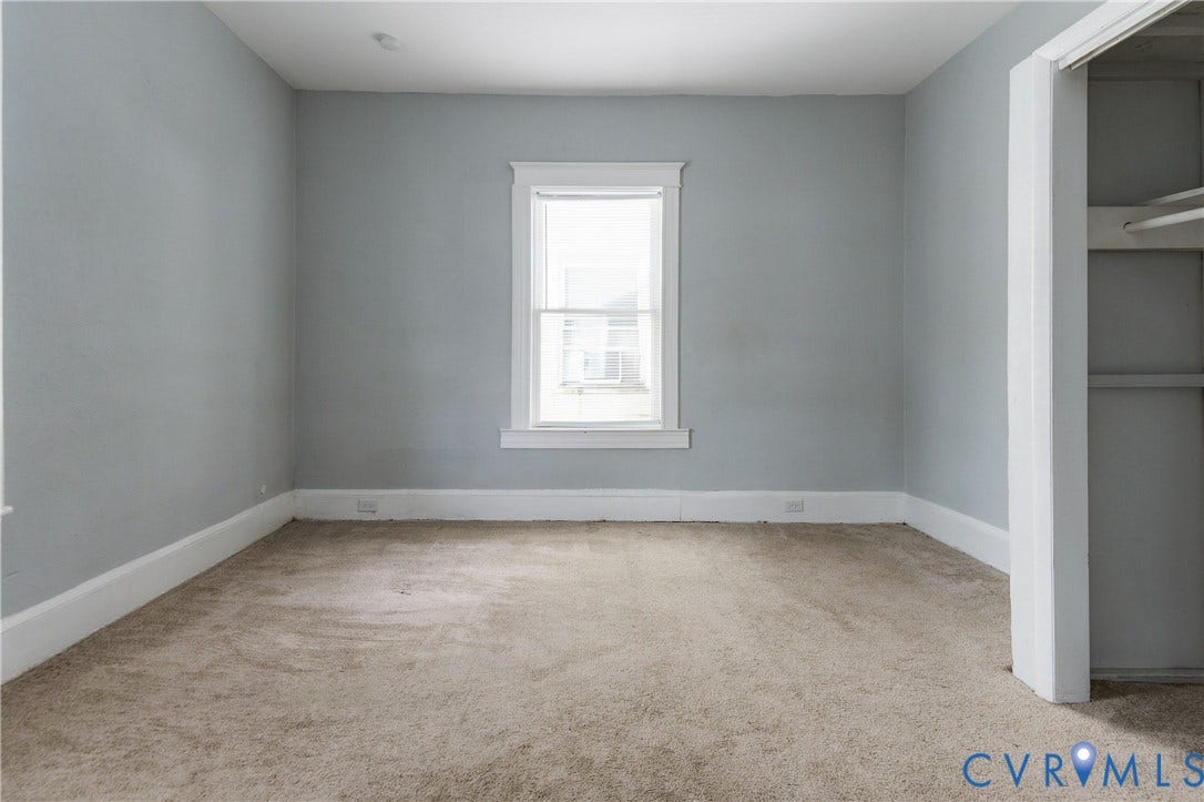 113 Spring Street, Pembroke, Petersburg, VA 23803 Neutral-toned wall paint, neutral carpeting, and a built-in closet with overhead shelving