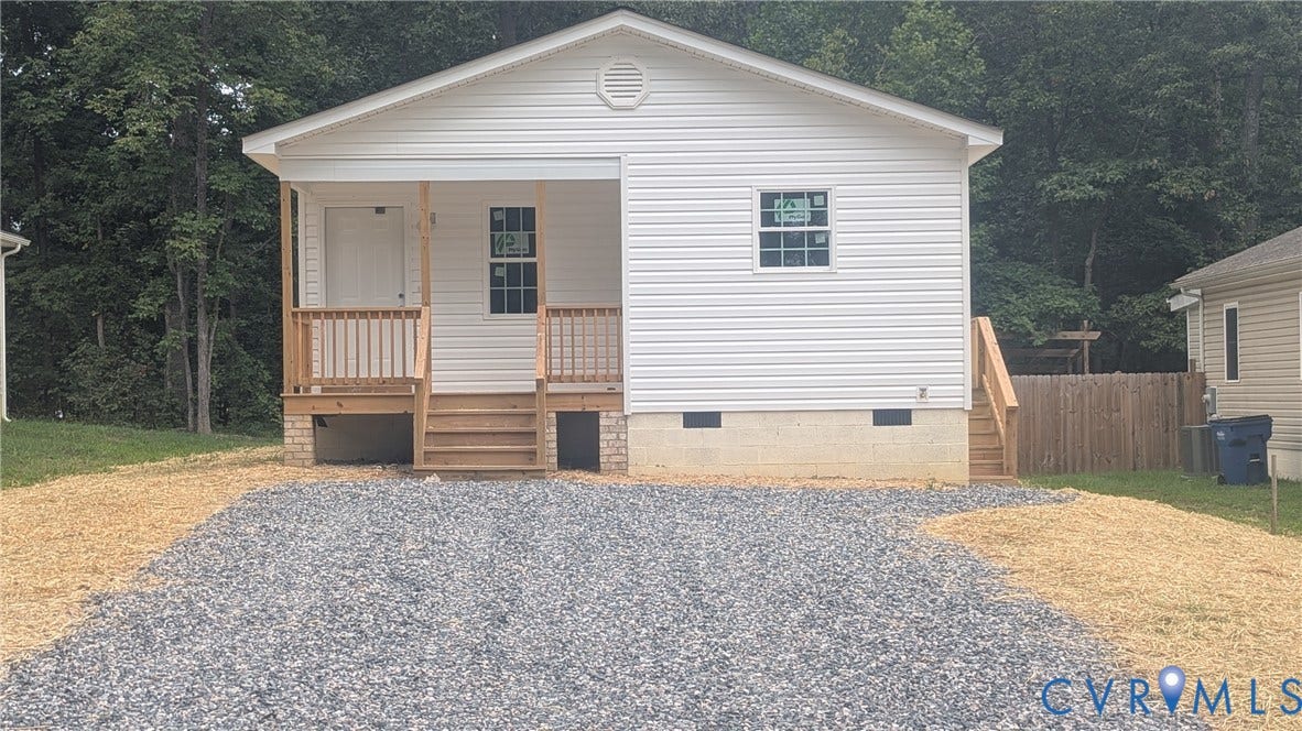 3006 Plumtree Street, South Chesterfield, VA 23834 Single-story exterior featuring white vinyl siding, a covered front porch with wooden railings, and a gravel driveway