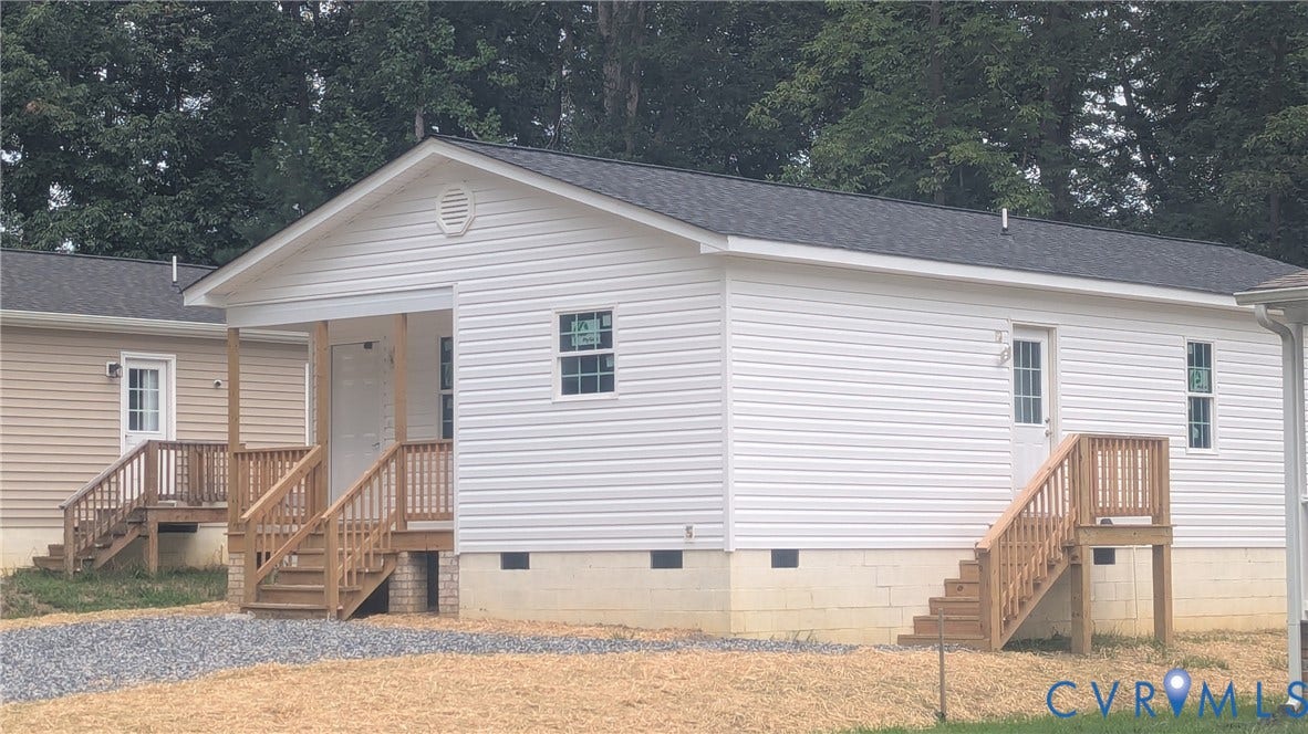 3006 Plumtree Street, South Chesterfield, VA 23834 Exterior featuring white vinyl siding, a covered front porch, wooden staircase railings, a shingled roof, and a gravel driveway