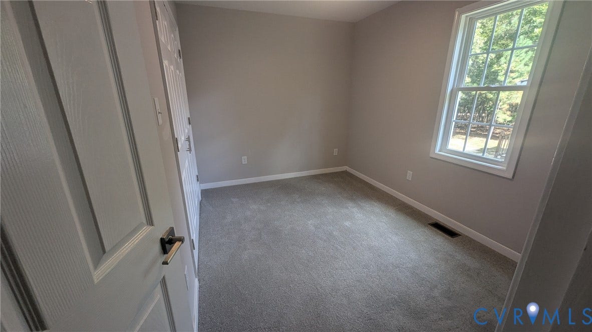 3006 Plumtree Street, South Chesterfield, VA 23834 Neutral wall tones, wall-to-wall carpeting, a multi-pane window, and a multi-panel interior door with brushed metal hardware
