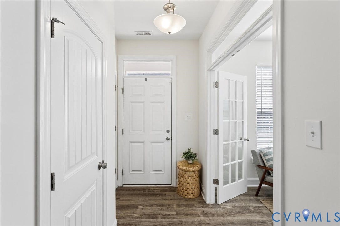 6177 Bowline Lane, Chesterfield, VA 23234 Entryway featuring LVP flooring, a six-panel exterior door with a transom window, and glass-paned French doors leading into the beautiful flex room.