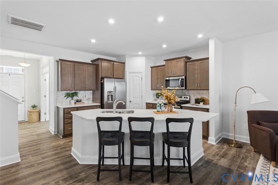 6177 Bowline Lane, Chesterfield, VA 23234 Expansive kitchen island with white quartz countertop, recessed lighting, and stainless steel appliances.