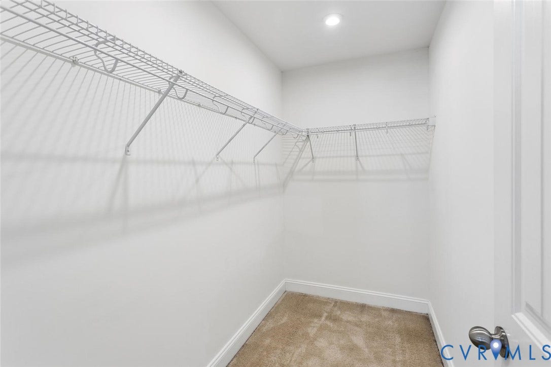 6177 Bowline Lane, Chesterfield, VA 23234 Spacious walk-in closet in your Primary Bedroom featuring wire shelving, recessed lighting, and carpet flooring.