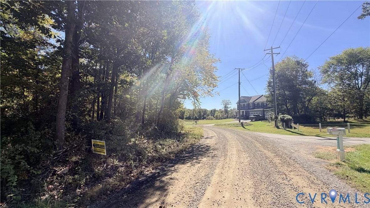 16106 Thoroughfare Road, Thoroughfare Rd, Broad Run, VA 20137 Unpaved access road bordering a wooded area featuring mature trees