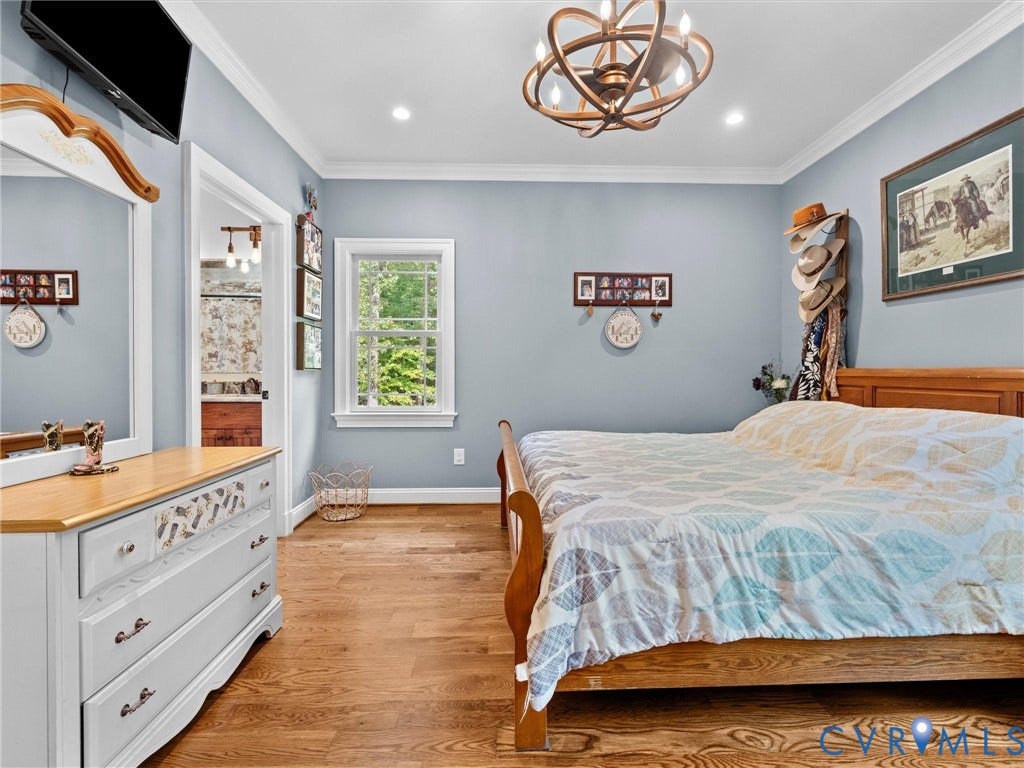 9877 Swinging Bridge Road, Taylors Grove Estates, Quinton, VA 23141 The spacious first-level primary suite offers the convenience of main-floor living, featuring beautiful hardwood floors, two closets, and a private en-suite bath. A comfortable and inviting retreat!