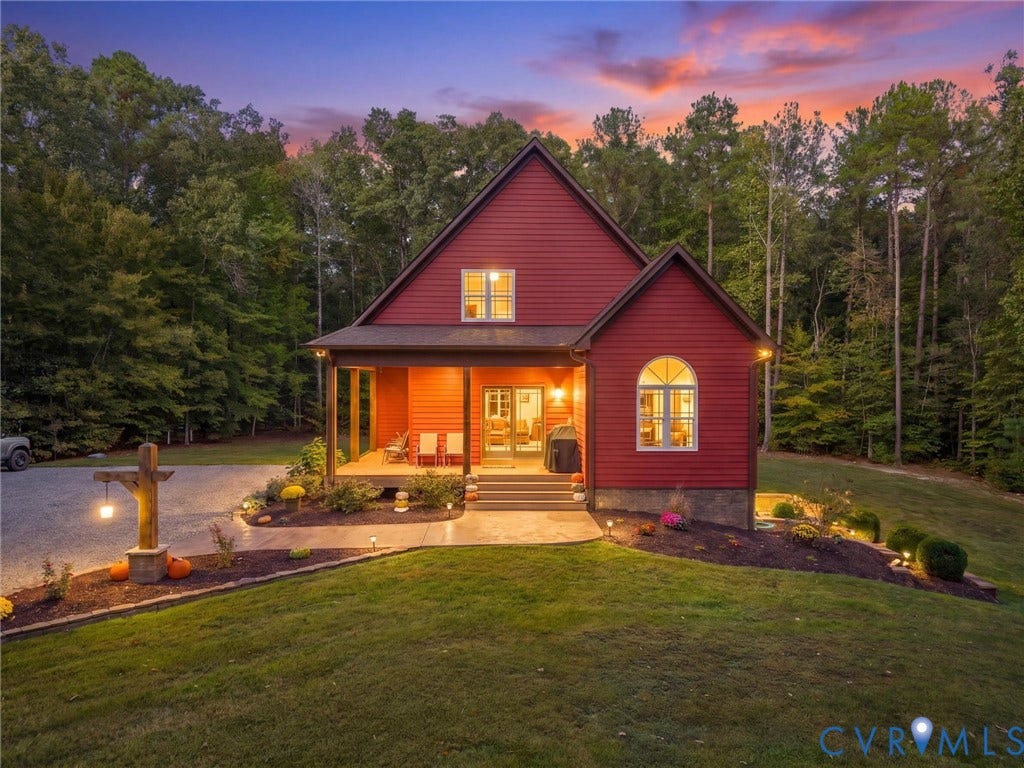 9877 Swinging Bridge Road, Taylors Grove Estates, Quinton, VA 23141 A picture-perfect evening at this charming country retreat! The warm glow of the home's exterior lighting, beautifully landscaped grounds, and breathtaking sunset create an inviting atmosphere. A peaceful place to unwind and enjoy the beauty of country living!