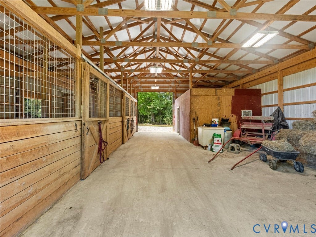 9877 Swinging Bridge Road, Taylors Grove Estates, Quinton, VA 23141 The charming 3-stall horse barn features a spacious center aisle, exposed wood trusses, attractive wood stall fronts, and a generous hay storage area with potential for conversion into two additional stalls. Convenient access to fenced pastures makes everyday horse care a breeze!
