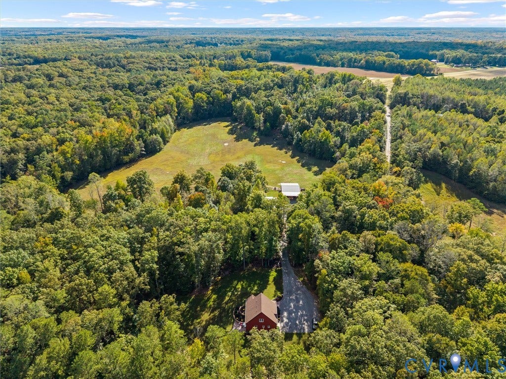 9877 Swinging Bridge Road, Taylors Grove Estates, Quinton, VA 23141 Experience the beauty of The Little Red Homestead from above! This stunning aerial view captures the property's expansive rolling pastures, mature woodlands, and peaceful countryside setting. With approximately 26.7 acres to explore, there's plenty of room for horseback riding, outdoor recreation, and enjoying the privacy and tranquility of country living!