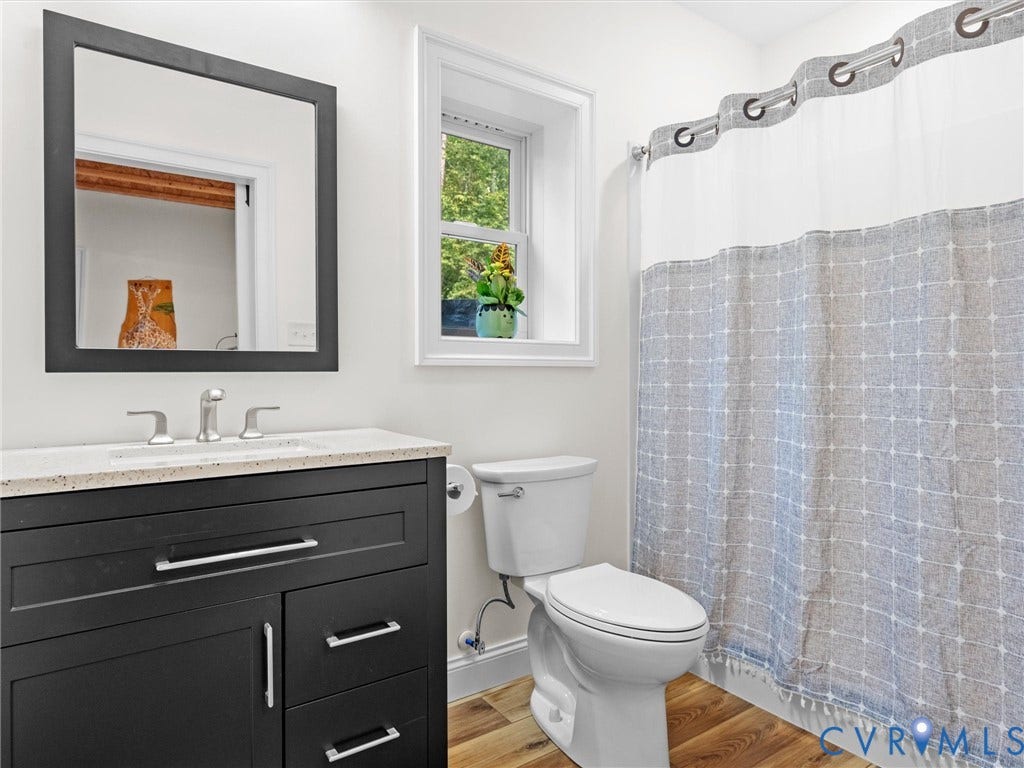 9877 Swinging Bridge Road, Taylors Grove Estates, Quinton, VA 23141 The fully finished basement bathroom features a spacious shower, stylish vanity, and natural light, offering added convenience for guests and activities on the lower level!