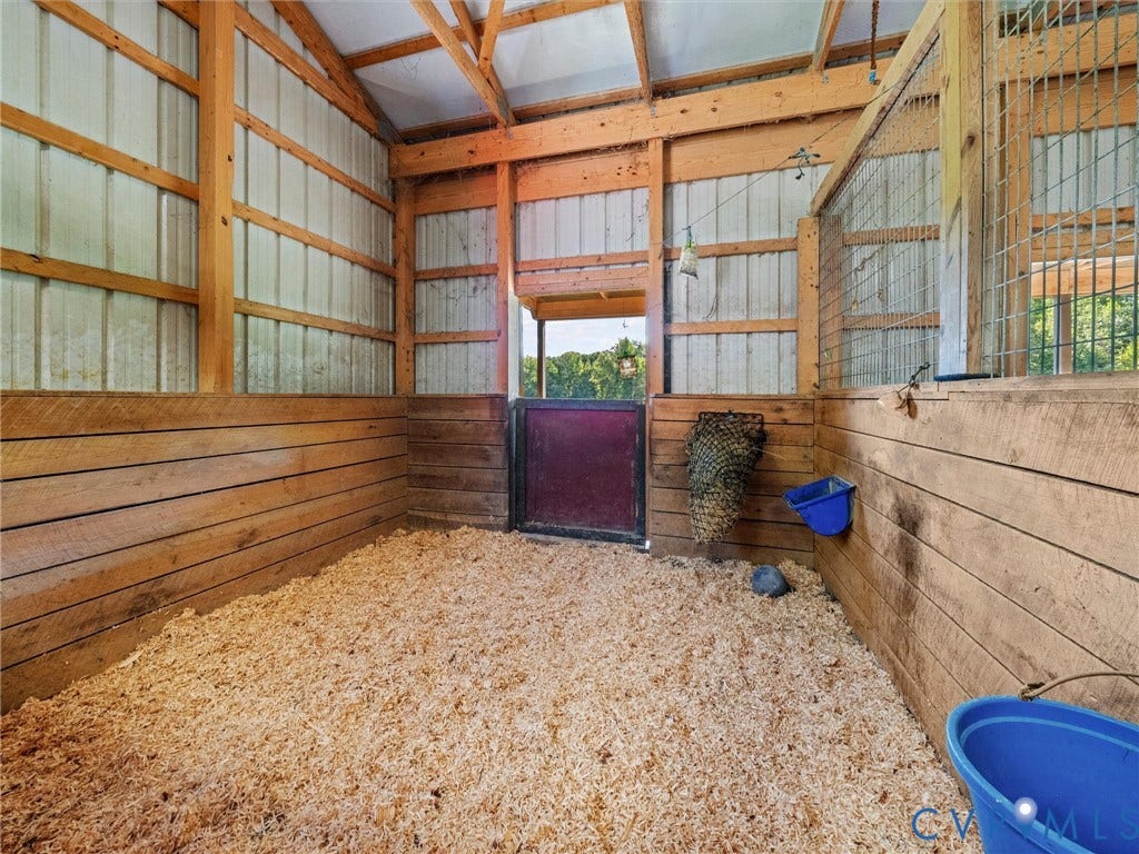9877 Swinging Bridge Road, Taylors Grove Estates, Quinton, VA 23141 Spacious horse stalls feature attractive wood-paneled walls, sturdy construction, and natural light, providing a comfortable setting for your horses. Thoughtfully designed for both functionality and everyday care!