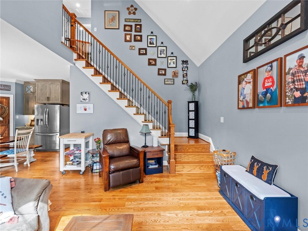 9877 Swinging Bridge Road, Taylors Grove Estates, Quinton, VA 23141 The beautiful open staircase features hardwood treads and elegant wrought iron balusters, adding architectural charm to the two-story family room. An open layout creates a seamless connection between the main living spaces and upper level!