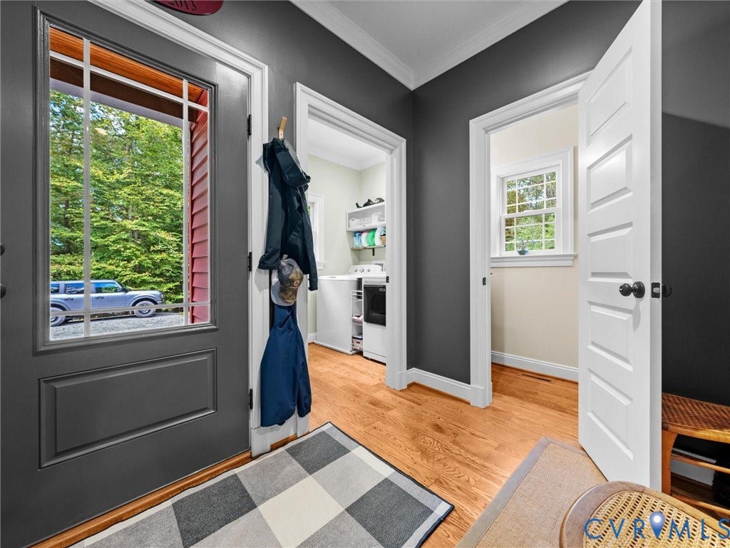 9877 Swinging Bridge Road, Taylors Grove Estates, Quinton, VA 23141 The welcoming side-entry foyer features beautiful hardwood floors, a convenient half bath, and easy access to the laundry room. A thoughtfully designed space that combines everyday functionality with farmhouse charm!