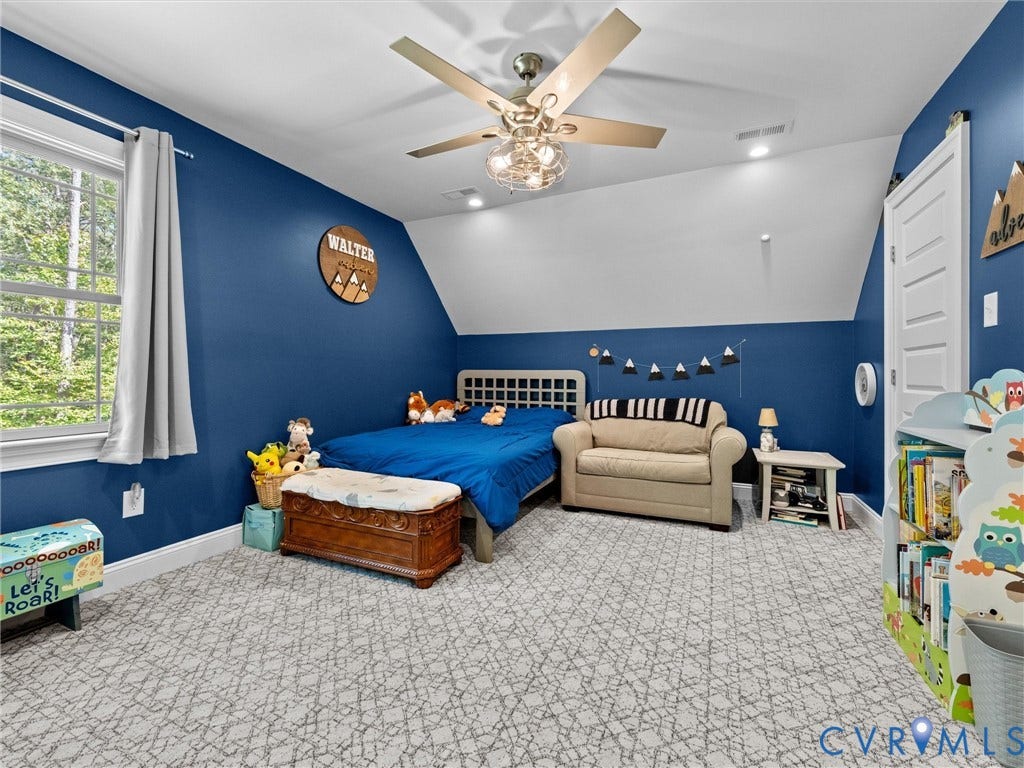 9877 Swinging Bridge Road, Taylors Grove Estates, Quinton, VA 23141 Spacious second-level Bedroom 3 features two walk-in closets, plush carpeting, a lighted ceiling fan, and two windows providing abundant natural light. A comfortable and inviting space with plenty of storage!