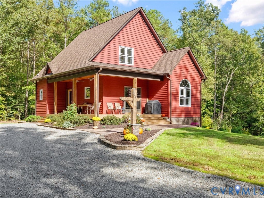 9877 Swinging Bridge Road, Taylors Grove Estates, Quinton, VA 23141 Welcome to The Little Red Homestead! This charming custom-built home features striking red siding, inviting covered front porches with rustic white oak columns, beautiful landscaping, and a welcoming country setting surrounded by mature trees. The perfect blend of farmhouse charm and peaceful country living!