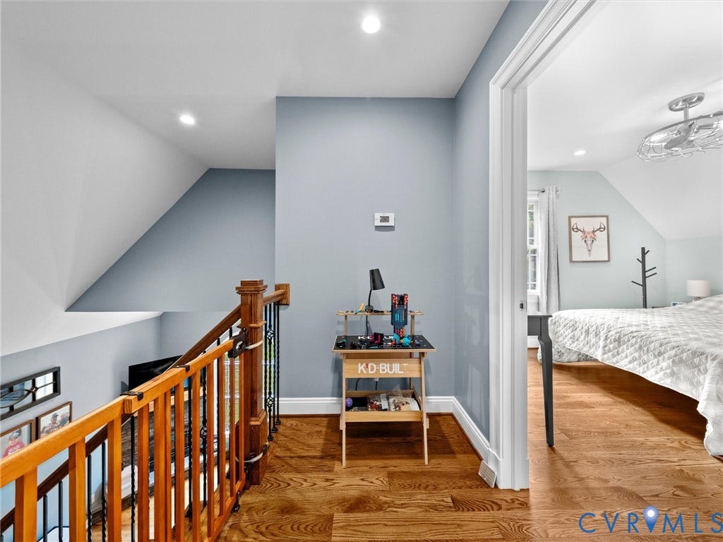 9877 Swinging Bridge Road, Taylors Grove Estates, Quinton, VA 23141 The spacious upper-level landing overlooks the two-story family room and features beautiful hardwood floors, wrought iron balusters, and access to the upstairs bedrooms. A bright, open design that adds to the home's inviting character!