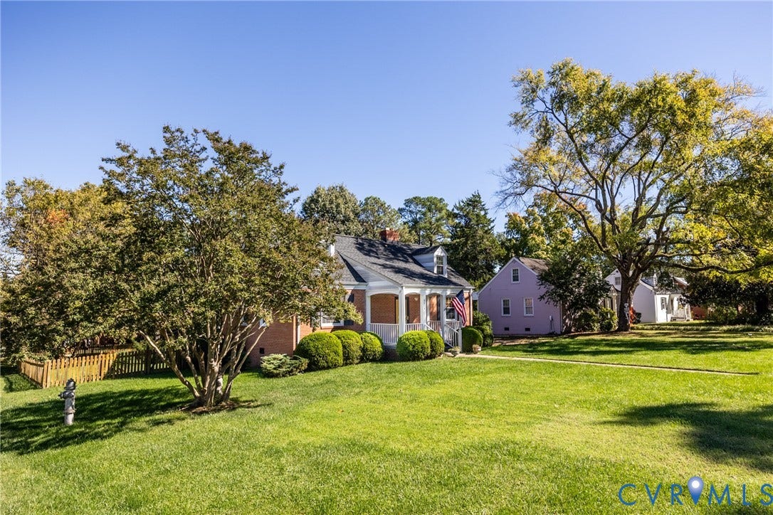6614 Monument Avenue, Westhaven, Henrico, VA 23226 Brick exterior residence featuring a covered front porch, gabled roofline, mature trees, and expansive lawn area