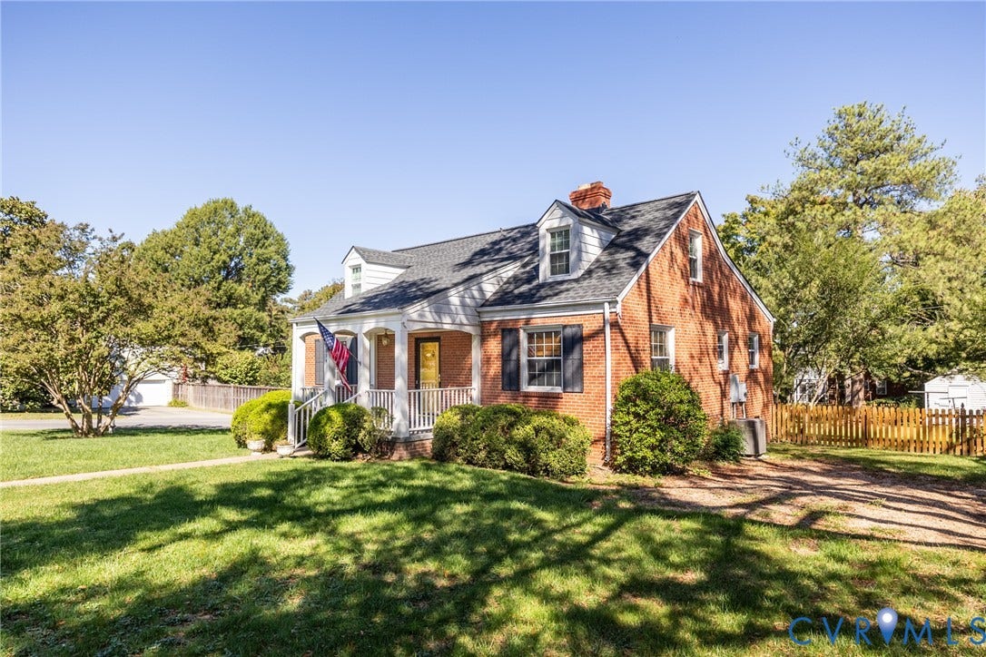 6614 Monument Avenue, Westhaven, Henrico, VA 23226 Classic brick exterior featuring a covered front porch, dual dormer windows, asphalt shingle roofing, and decorative shutters