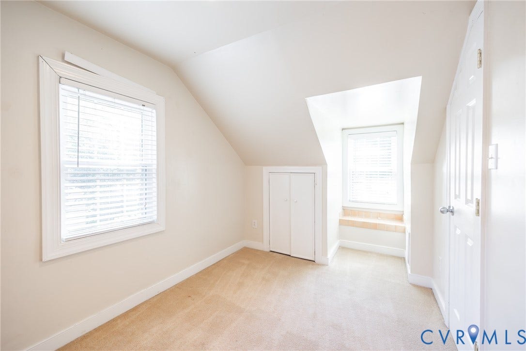 6614 Monument Avenue, Westhaven, Henrico, VA 23226 Interior space featuring vaulted ceilings, carpeted flooring, built-in storage cabinetry, a recessed window nook, and dual windows