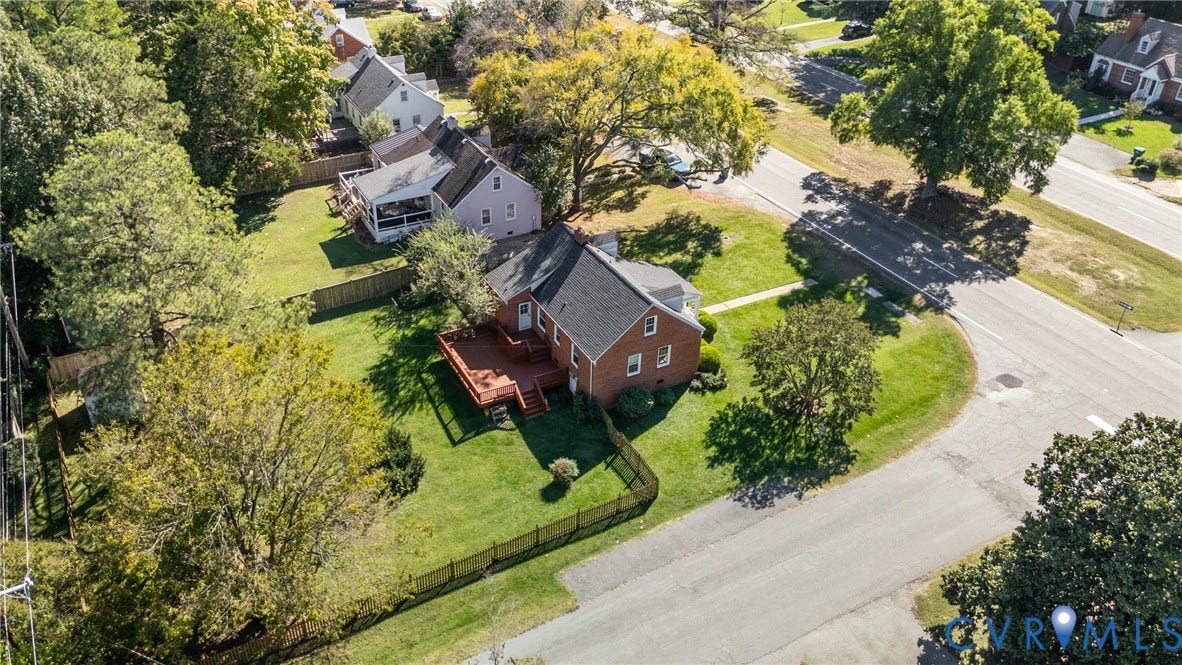 6614 Monument Avenue, Westhaven, Henrico, VA 23226 Brick exterior residence featuring an elevated wood deck, shingle roofing, and a fenced yard with mature trees