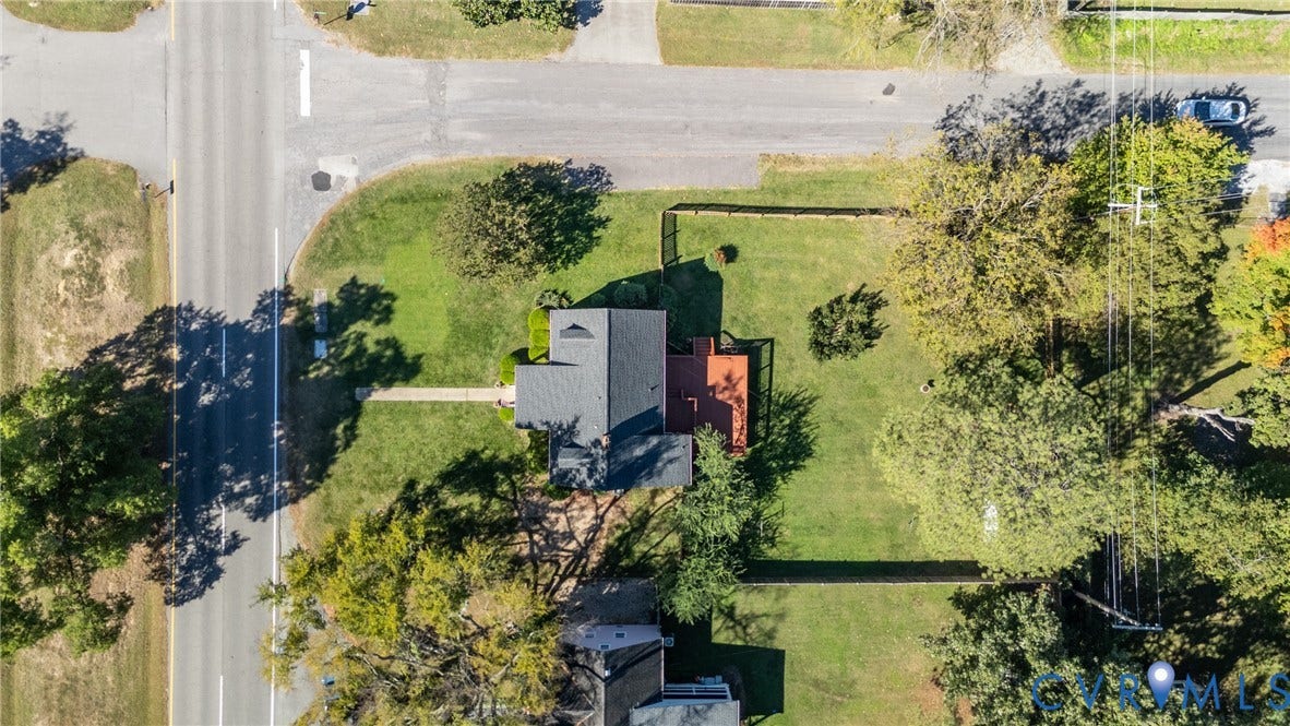 6614 Monument Avenue, Westhaven, Henrico, VA 23226 Aerial perspective of a corner lot featuring a dark shingle roof, integrated deck, and fenced grounds with mature trees