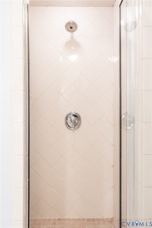 6614 Monument Avenue, Westhaven, Henrico, VA 23226 Walk-in shower featuring diamond-patterned wall tile, grid-patterned floor tile, chrome-finish shower head, and chrome-finish pressure balance valve