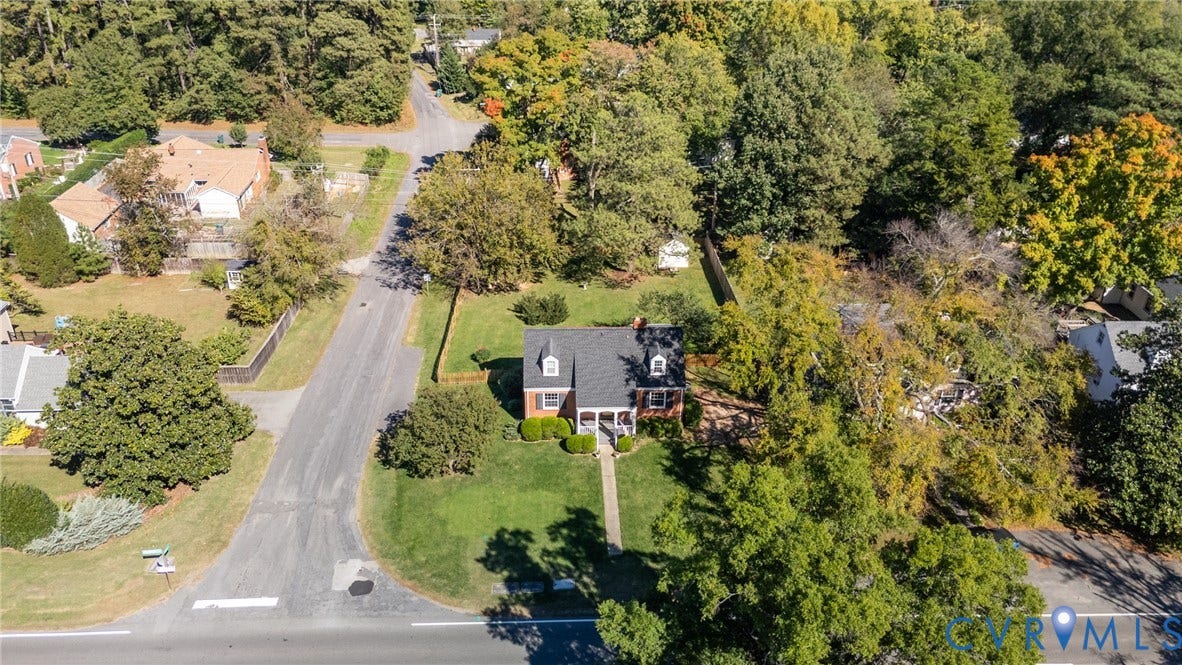 6614 Monument Avenue, Westhaven, Henrico, VA 23226 Aerial perspective of a detached residence featuring a brick facade, dormer windows, a pitched roof, and a mature tree-lined lot