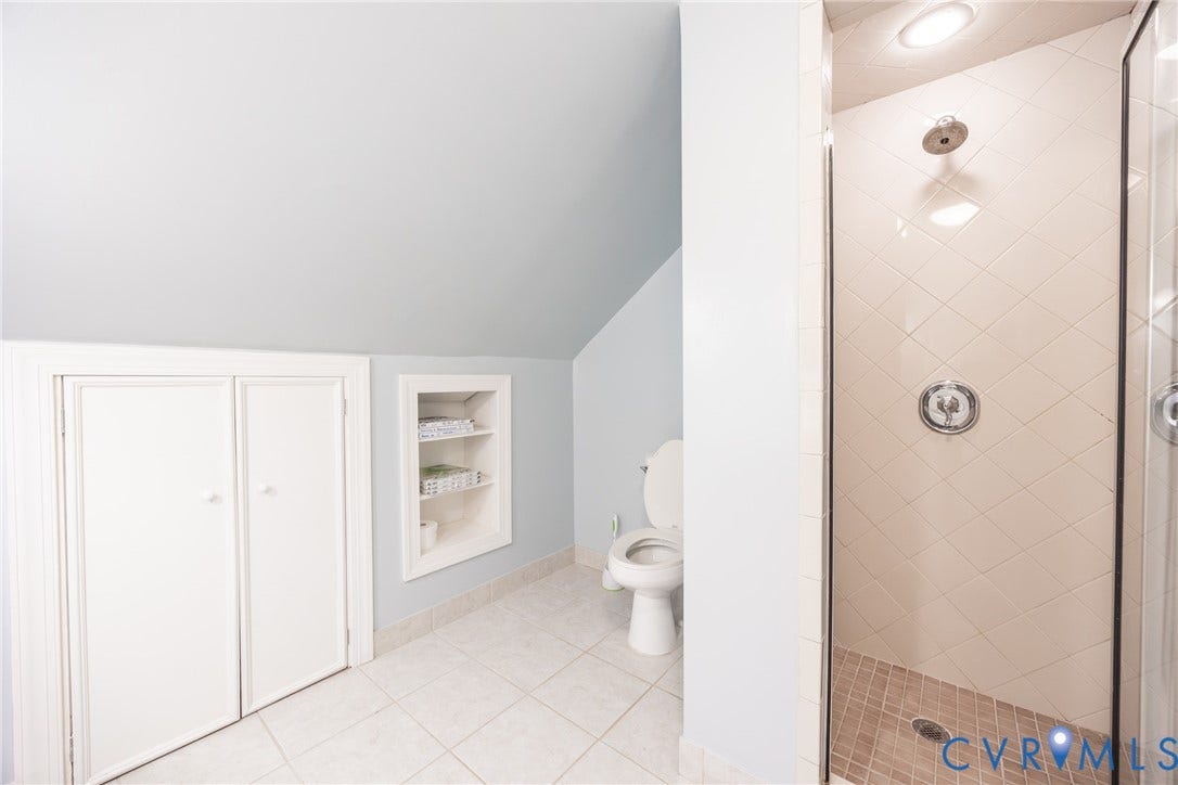 6614 Monument Avenue, Westhaven, Henrico, VA 23226 Bathroom featuring a walk-in shower with diamond-patterned wall tile, built-in recessed shelving, dual-door storage cabinetry, and tile flooring