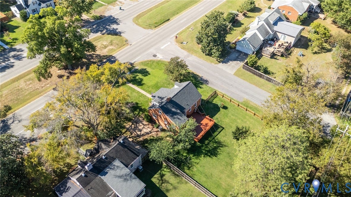 6614 Monument Avenue, Westhaven, Henrico, VA 23226 Aerial perspective of a detached property featuring a shingled roof, brick exterior, rear wood deck, and expansive grass lawn enclosed by wooden fencing