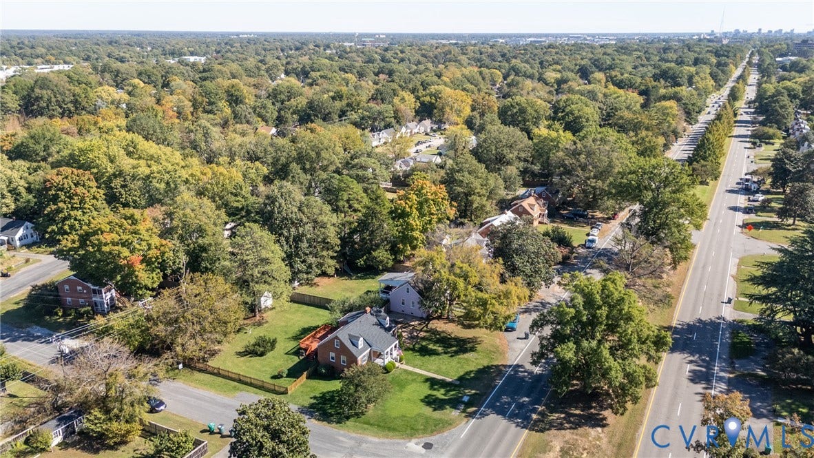 6614 Monument Avenue, Westhaven, Henrico, VA 23226 Aerial perspective of a corner lot property featuring a masonry exterior, a pitched roof, a paved driveway, and established surrounding tree canopy