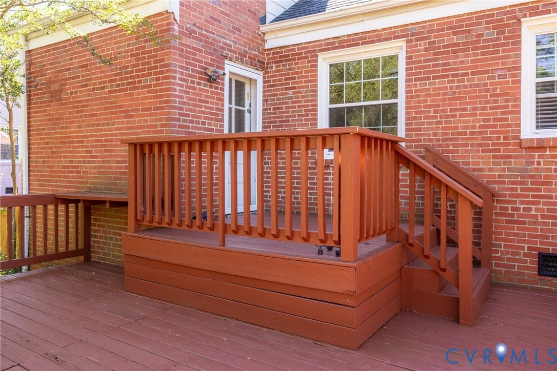 6614 Monument Avenue, Westhaven, Henrico, VA 23226 Exterior red brick facade featuring a raised wood-finish deck with integrated railing, matching staircase, and multi-pane window