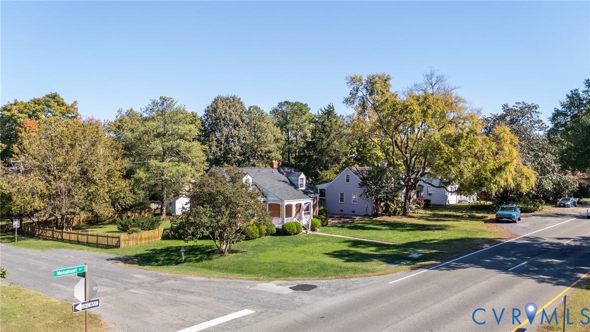 6614 Monument Avenue, Westhaven, Henrico, VA 23226 Corner lot exterior featuring a gable roof, covered front porch, and expansive lawn with mature trees and perimeter wood fencing