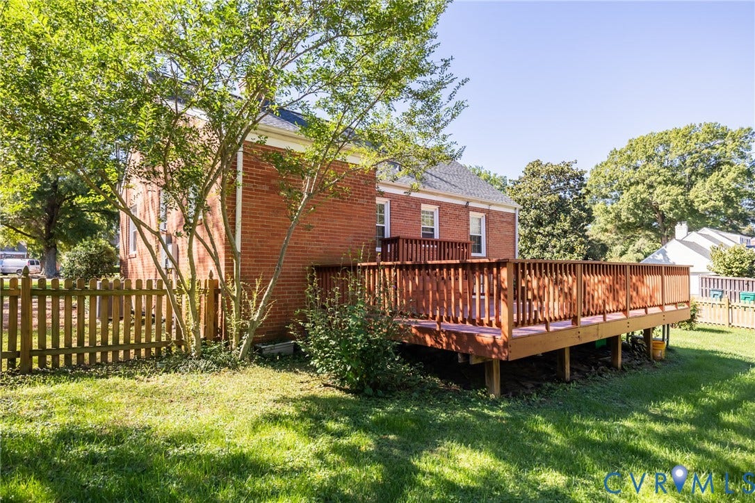 6614 Monument Avenue, Westhaven, Henrico, VA 23226 Brick exterior featuring a spacious raised wooden deck and a surrounding wood-slat privacy fence