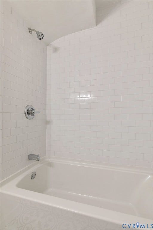 7263 Grace Lane, Mechanicsville, VA 23111 White subway tile shower surround featuring a full-sized bathtub with chrome fixtures