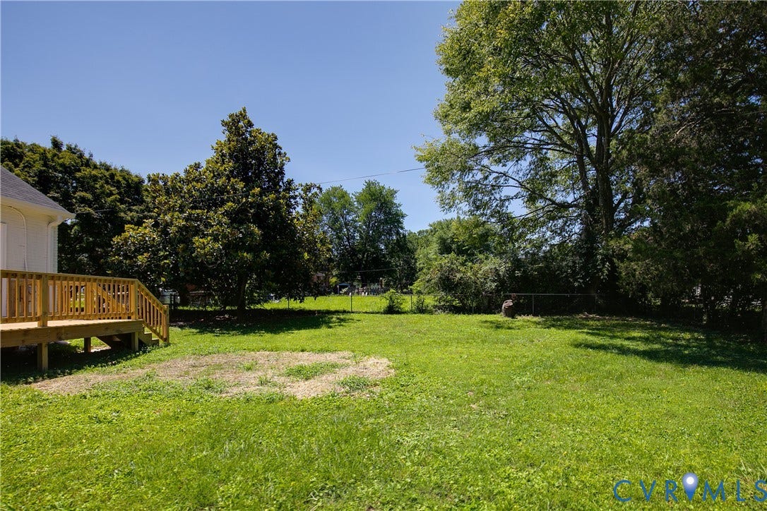 7263 Grace Lane, Mechanicsville, VA 23111 Expansive grassy yard featuring a newly constructed wood deck with railings and steps