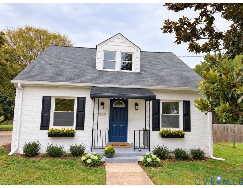7263 Grace Lane, Mechanicsville, VA 23111 Painted brick exterior featuring a front-facing dormer, black shutters, metal door awning, and window-mounted planters