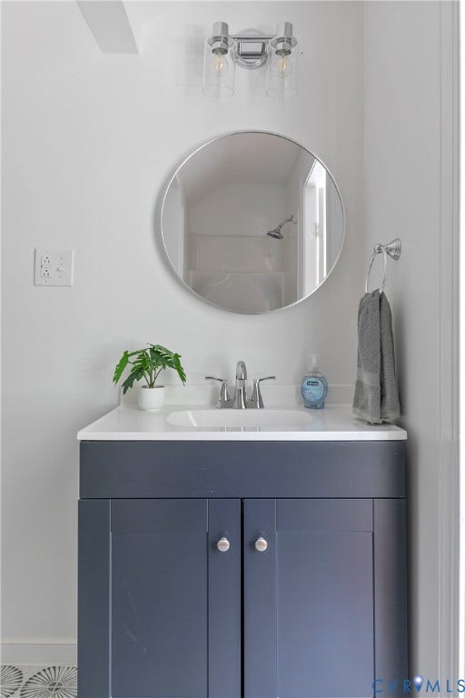 7263 Grace Lane, Mechanicsville, VA 23111 Modern bathroom vanity featuring a dark navy cabinetry base with dual doors, white quartz countertop, and integrated rectangular sink