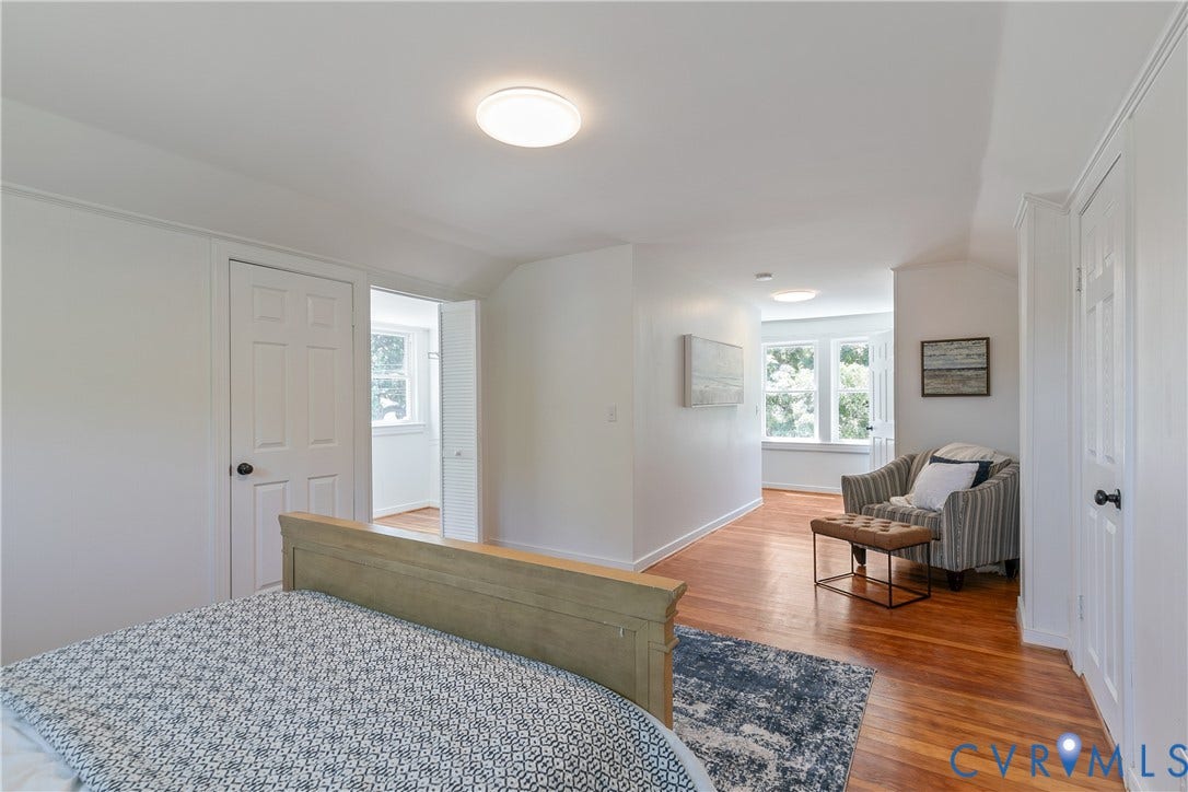 7263 Grace Lane, Mechanicsville, VA 23111 Hardwood flooring spanning the room, white walls, and bright windows