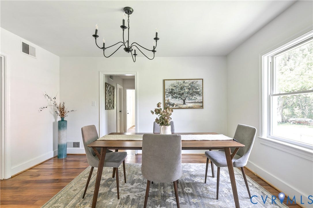 7263 Grace Lane, Mechanicsville, VA 23111 Dining area featuring wood-finish flooring, white walls, and a multi-light black chandelier