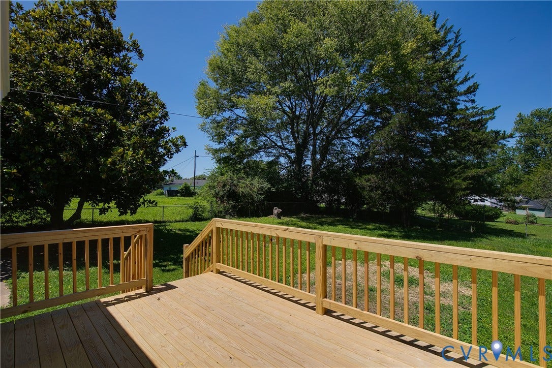 7263 Grace Lane, Mechanicsville, VA 23111 Spacious wooden deck with natural wood finish, featuring a railing system and steps