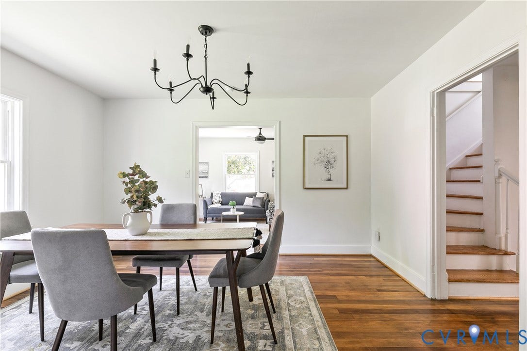 7263 Grace Lane, Mechanicsville, VA 23111 Dining area featuring wood-finish flooring, a contemporary chandelier, white baseboards, and a doorway opening to an additional living space