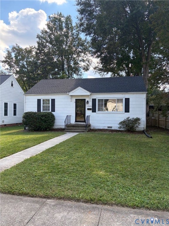 6523 Stuart Avenue, Richmond, VA 23226 White exterior siding, black window shutters, gabled roofline, front entryway with a decorative hood, and concrete walkway