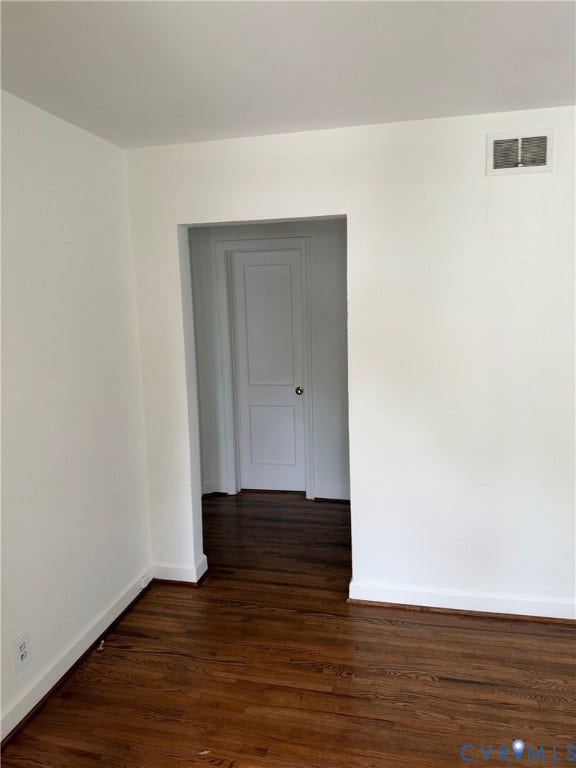6523 Stuart Avenue, Richmond, VA 23226 Dark-toned wood-finish flooring with a two-panel interior door