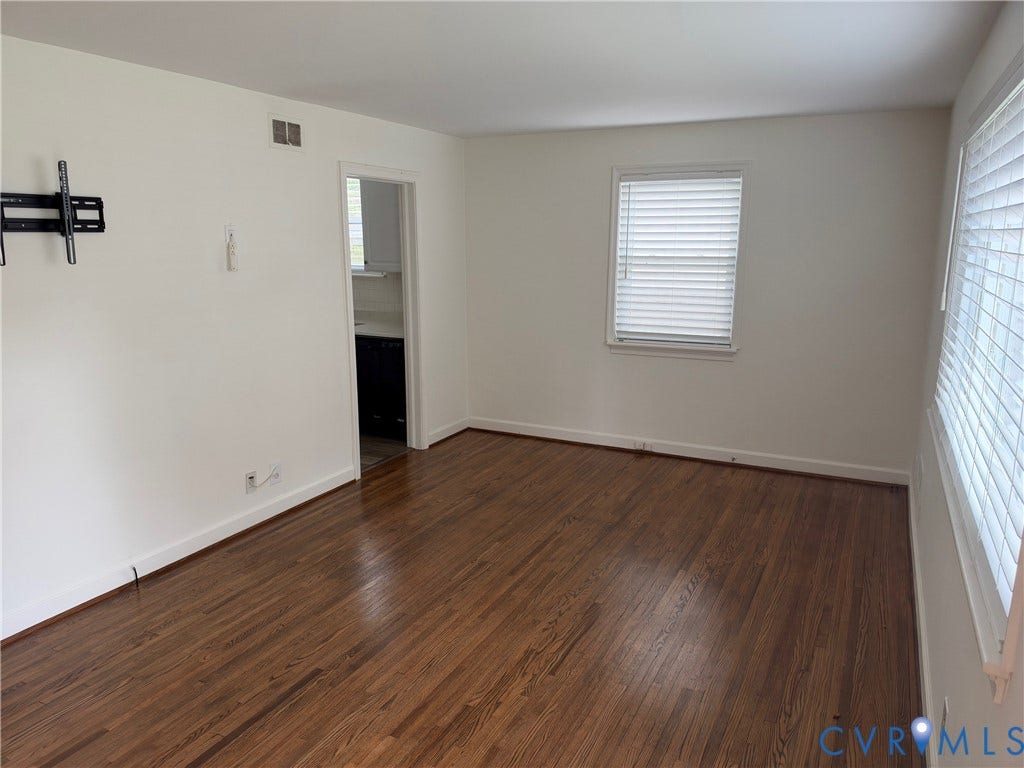 6523 Stuart Avenue, Richmond, VA 23226 Wood-finish flooring, neutral wall tones, and horizontal window blinds