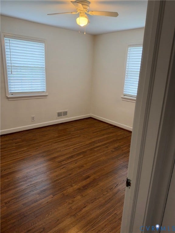 6523 Stuart Avenue, Richmond, VA 23226 Room featuring wood-finish flooring, two windows with horizontal blinds, and a white ceiling fan with integrated lighting