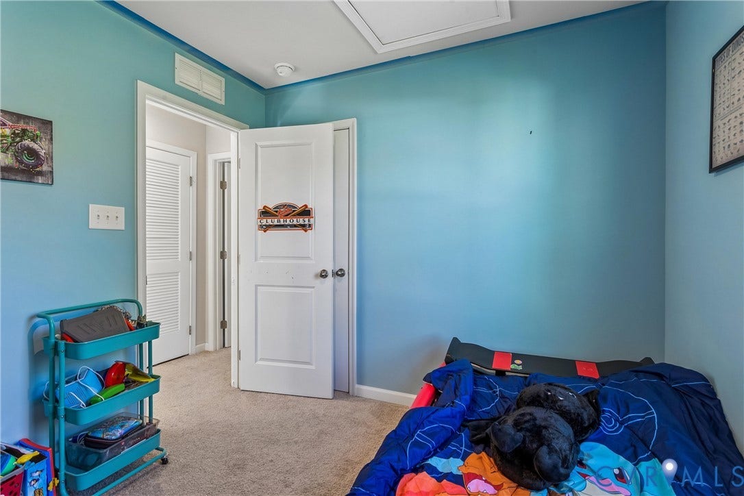 Room featuring carpeting, white panel doors, and neutral wall tones