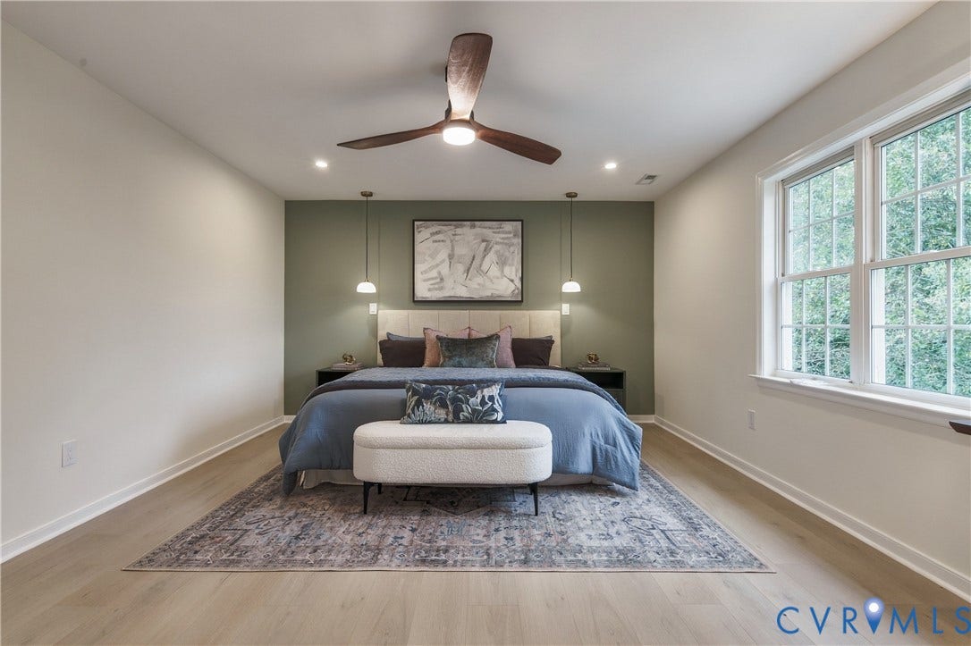 8060 Pebblepath Parkway, Hanover, VA 23111 Wood-finish flooring, multi-pane window, ceiling fan with integrated lighting, dual pendant fixtures, and an accent wall