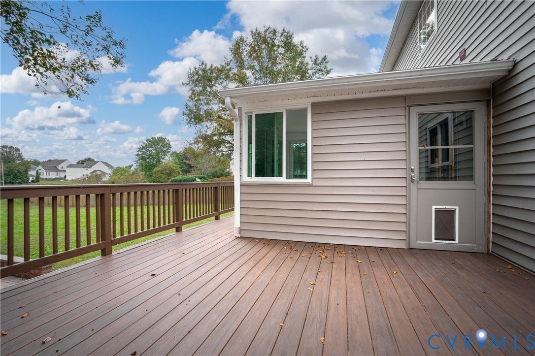 8060 Pebblepath Parkway, Hanover, VA 23111 Elevated wood-finish deck with a rail balustrade, horizontal siding exterior, and a glass-paneled entry door